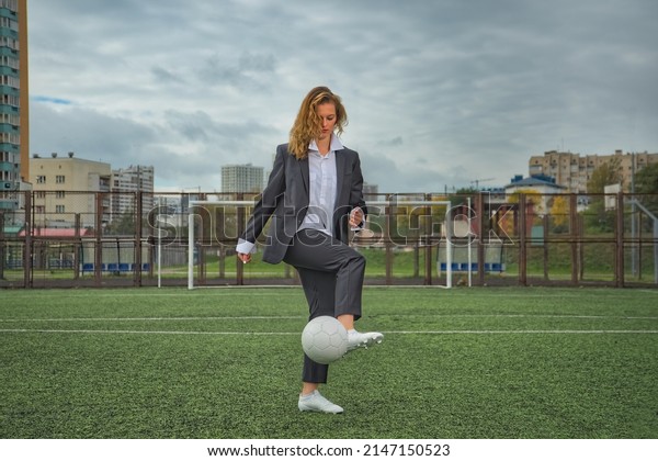 woman soccer player with ball on the field. ball\
dribbling, feint