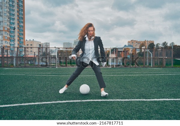 woman soccer player with ball on the field. ball\
dribbling, feint