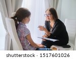 Woman social worker talking to girl. Child psychology, mental health.