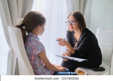 Woman social worker talking to girl. Child psychology, mental health. - Shutterstock ID 1517601026