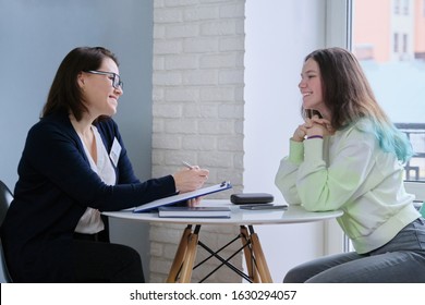 Woman social worker talking to teenage girl. Psychological assistance in adolescence. Mental health of adolescent children