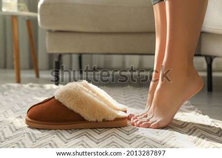 Woman with soft slippers at home, closeup