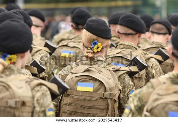 Woman soldier. Woman in army. Ukrainian flag on\
military uniform. Ukraine\
troops.