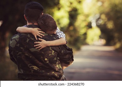 Woman and soldier in a military uniform say goodbye before a separation - Shutterstock ID 224368270