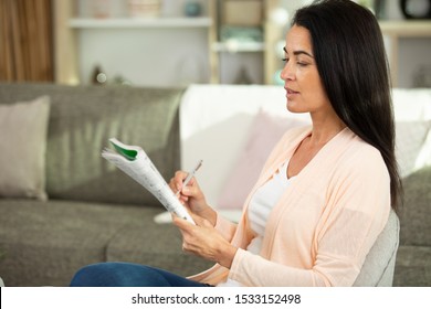 Woman Is Solving Crossword Puzzles