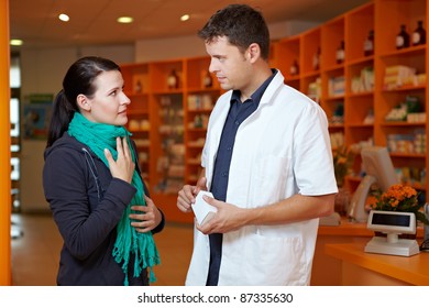 Woman With Sore Throat In Pharmacy Talking To Pharmacist