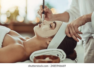 Woman, spa and facemask with brush for application, pamper weekend and skincare wellness with client. Facialist, treatment and skin rejuvenation or pore tightening, relaxation and facial with people - Powered by Shutterstock