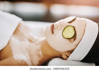 Woman, spa and facemask with relaxing cucumber, organic treatment and eye rejuvenation or skin wellness. Pore tightening, beauty facial and client for skincare pamper, hydration and soothing detox - Powered by Shutterstock