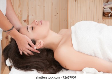woman in spa getting a massage on her face