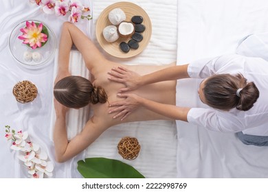 Woman At Spa Thai Massage Tow View, Beauty Treatments Concept. Orchid And Lotus Flowers Coconut Stones And Herb Pouches