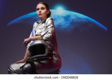 Woman space explorer against background with planet