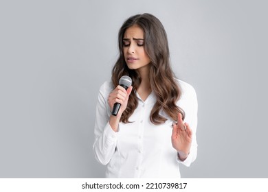 Woman Speech, Business Woman Holding A Microphone. Microphone Speech Speaking Concept. Young Beautiful Woman Singing Song Using Microphone.