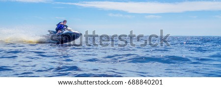Woman speeding on jet ski on lake during summer vacation