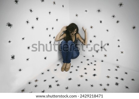 Woman, spiders and scream in fear at studio for arachnophobia problem, scared or shouting. Female person, insects and trapped with struggle suffering for danger panic or terror, poisonous or horror