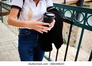 Woman Spill Coffee From Paper Cup To White Shirt And Jeans. Large Coffee Spot On White Shirt