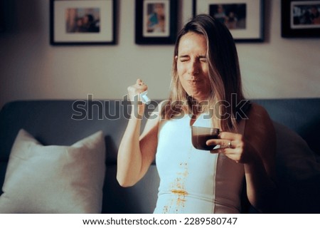 
Woman Spilling Hot Coffee on her Favorite White Dress. Irritated lady having staining her clothing with a warm drink
