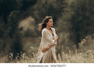 Woman and spirituality, a young female in light clothes meditates and contemplates nature. Side view of Caucasian woman and relaxation - Powered by Shutterstock