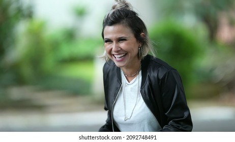 Woman spontaneous real life laugh and smile outside. Person bursts laugh out loud - Shutterstock ID 2092748491