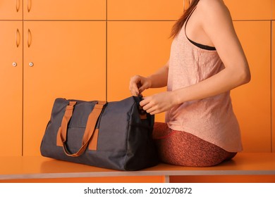 Woman With Sport Bag In Gym Locker Room