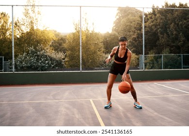 Woman, sport and ball as ready on basketball court for challenge as player or athlete for training. Female person, warm up and outdoor for competition, match and game in physical activity or exercise - Powered by Shutterstock