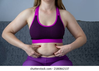 woman in sport outfit with extra weight, kg belly, not perfect body is exercising and loosing weight, concept of sport and fitness and healthy lifestyle. Body positive