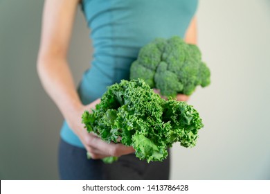 Woman In Sport Wear Holding Broccoli And Kale. Healthy Lifestyle, Woman Eating Healthy Food, Dieting