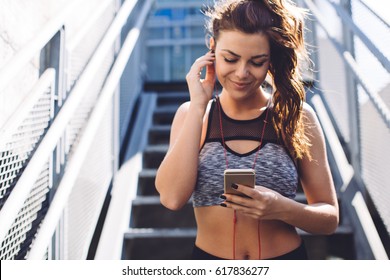 Woman in sport wear using mobile phone