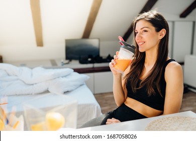 Woman In Sportswear Drinking Sweet Orange Amino Acid Powder Smoothie After Home Workout.Keto Supplement.After Exercise Liquid Meal.Weight Loss Fitness Nutrition Diet Post Work Out.Organic Citrus Fruit