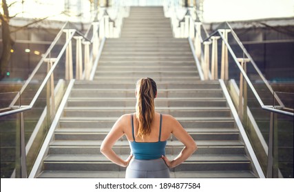 Woman in sportswear preparing for stair run. - Powered by Shutterstock