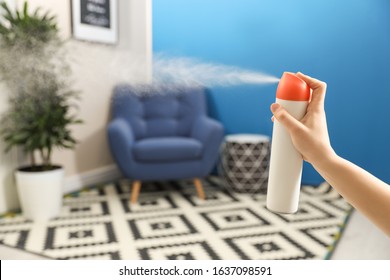 Woman Spraying Air Freshener At Home, Closeup