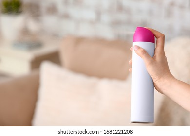 Woman Spraying Air Freshener In Room