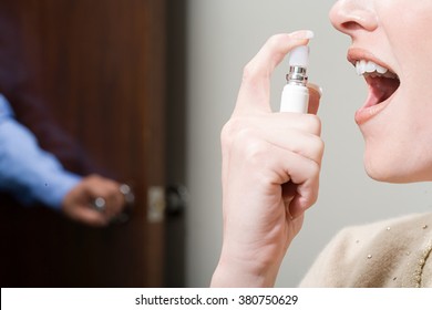 Woman Spraying Breath Freshener