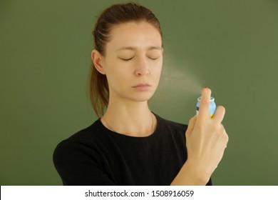 Woman Spraying Facial Mist On Her Face, Summertime Skin Care Concept