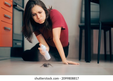 
Woman Spraying with Insecticide Over an Ant on the Kitchen Floor. Homeowner dealing with pest infestation problem in her own apparent

