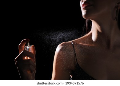 Woman Spraying Luxury Perfume On Black Background, Closeup