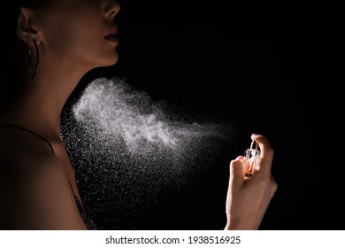 Woman Spraying Luxury Perfume On Black Background, Closeup