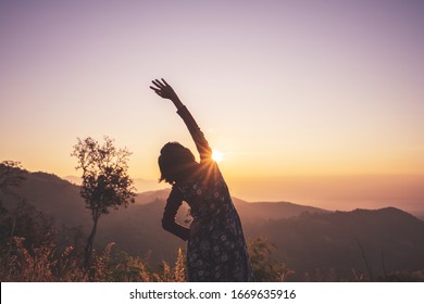 Woman Spreading Hands With Joy And Inspiration At Sunrise.
