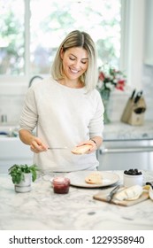 Woman Spreading Vegan Cream Cheese On A Toast