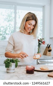 Woman Spreading Vegan Cream Cheese On A Toast