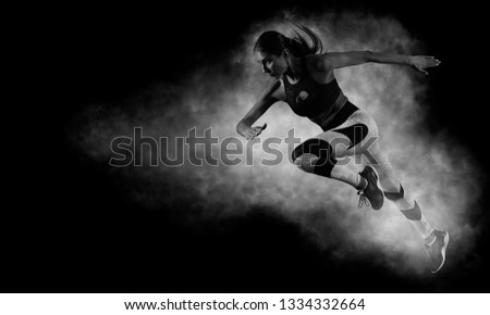 Woman sprinter leaving starting. Exploding start