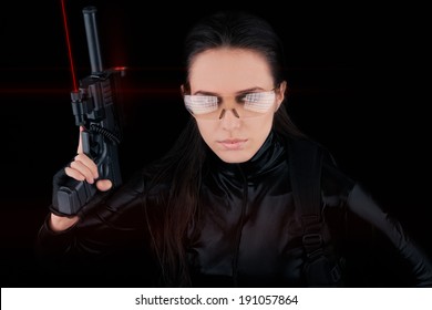 Woman Spy Holding Gun With Laser Sights - Woman In A Black Leather Suit Holding A Gun With Laser Sights 