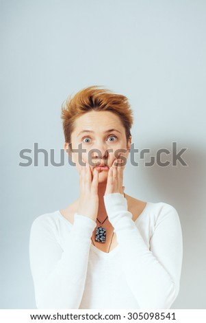 woman squeezes her cheeks