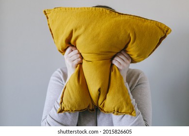 Woman squeezes a pillow with her hands, the concept of anger, irritation