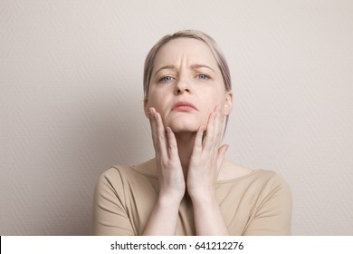 A Woman Squeezes And Pulls Your Skin. Are Dissatisfied With Their Appearance, Afraid Of Getting Old. Low Self-esteem, Fears, Neuroses, Psychology Of Aging, Gerontology, Old Age, Middle Age.