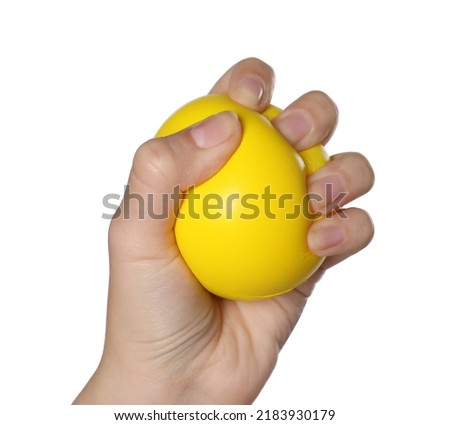 Woman squeezing antistress ball on white background, closeup