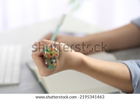 Woman squeezing colorful slime, closeup. Antistress toy