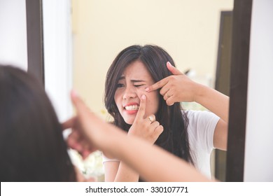 Woman Squeezing Pimples In Her Cheek, Look At The Mirror