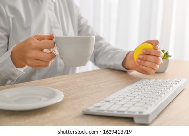 Woman Squeezing Stress Ball While Working In Office