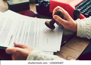 Woman Stamping An Official Document