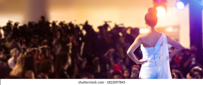 Woman stand in front of Media Press Television camera as Model Fashion Show or Miss Beauty queen pageant contest to empower people, Light to back view of unrecognizable woman - Shutterstock ID 1822097843